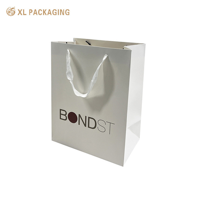 Купить XL Packaging Фабрика индивидуальной упаковки Индивидуальный логотип 250 г/м² Бумажный пакет для покупок с мелованной бумагой с белой лентой и внутренней коробкой Производство в сети